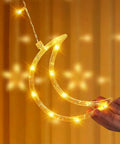 Dazzle Bright Ramadan Curtain String Lights With 138 LEDs Warm White Star Moon Fairy Lights 8 Lighting Modes With Remote 12 Hooks For Bedroom Or Outdoor Party Decor Create Cozy Ramadan Home Vibe showing a glowing moon shape.