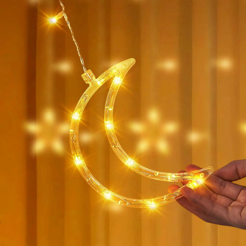 Dazzle Bright Ramadan Curtain String Lights With 138 LEDs Warm White Star Moon Fairy Lights 8 Lighting Modes With Remote 12 Hooks For Bedroom Or Outdoor Party Decor Create Cozy Ramadan Home Vibe showing a glowing moon shape.