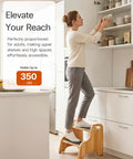 Premium Wooden Two Step Stool Duo Featuring Tough As Nails Build Quality And Wide Non Slip Steps That Handle Up To 350 Lbs Like A Champ For Kitchen And Bath in use to reach high shelves.