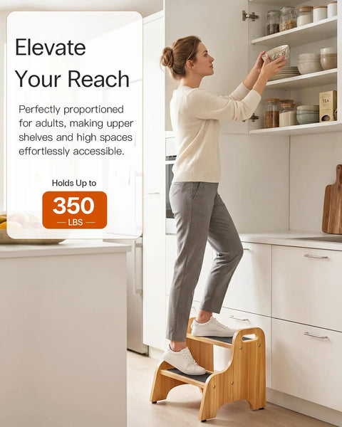 Premium Wooden Two Step Stool Duo Featuring Tough As Nails Build Quality And Wide Non Slip Steps That Handle Up To 350 Lbs Like A Champ For Kitchen And Bath in use to reach high shelves.