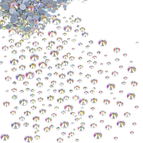 Crystal AB Flatback Hotfix Rhinestones Set 6500 Pieces in 6 Sizes SS6 SS10 SS12 SS16 SS20 SS30 scattered on a surface