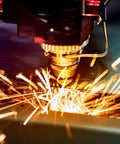 Close-up of a CNC milling tool cutting 304 stainless steel sheet with bright sparks.