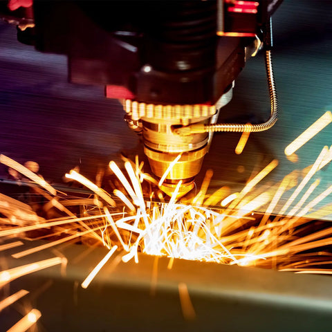 Close-up of a CNC milling tool cutting 304 stainless steel sheet with bright sparks.