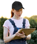 Person wearing lightweight adjustable cotton dad hat for men with relaxed fit breathable summer cap writing outdoors