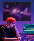 A young adult focused on a laptop in a studio, with a colorful starry backdrop and 8 Pack Fiber Optic Starlight Soundproof Foam Panels.