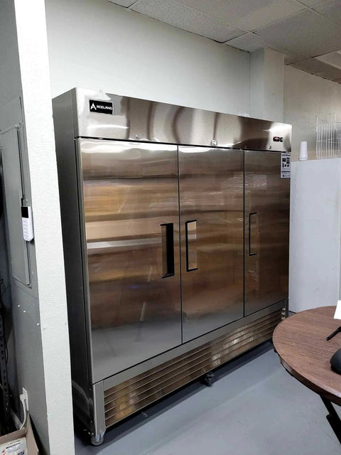 Rock Solid 82 Inch Wide Commercial Reach In Freezer With Three Doors And 72 Cubic Feet Capacity Stainless Steel in a kitchen setting.