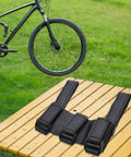 Ride Ready Golf Cart Speaker Holder Strap And Bike Rail Mount on wooden table outdoors