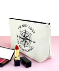Im Not Lost Geocaching Gift Makeup Bag For Women Travel Essentials Zipper Pouch with compass design on pink surface