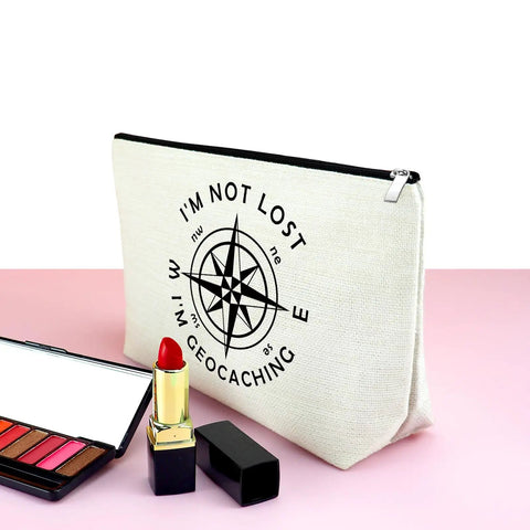 Im Not Lost Geocaching Gift Makeup Bag For Women Travel Essentials Zipper Pouch with compass design on pink surface