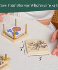 Person assembling Ultra Portable 3x3 Inch Flower Press Kit Two Pack for Adults with flower designs on top wood panel.