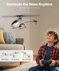 Child with remote controls Easy Start RC Helicopter For Beginners With Gyro 2.4GHz Remote OneKey Takeoff And Landing indoors.