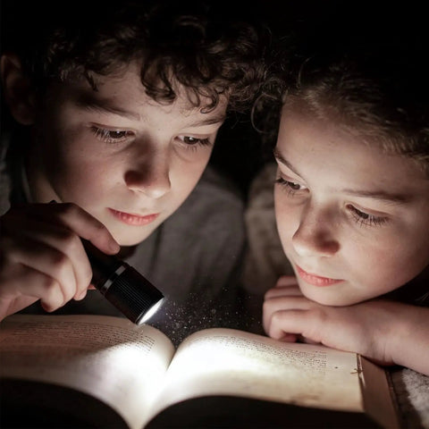 Children reading by Compact LED Mini Flashlight With Tiny But Mighty Brightness, Waterproof And Energy Efficient, Ultra Portable