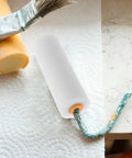 Twelve Pack Nifty Little Mini Sponge Rollers With Cushioned Handles For Walls And Detail Work Gives You A Straight Up Flawless Coat Every Time Super Simple Cleanup Built Solid For Daily Hustle, showing mini roller on a surface.