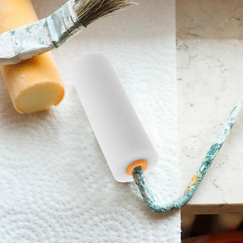 Twelve Pack Nifty Little Mini Sponge Rollers With Cushioned Handles For Walls And Detail Work Gives You A Straight Up Flawless Coat Every Time Super Simple Cleanup Built Solid For Daily Hustle, showing mini roller on a surface.