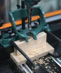 Mortising attachment for drill press; green cast-iron frame on wooden base