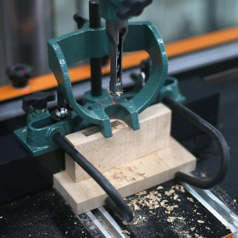 Mortising attachment for drill press; green cast-iron frame on wooden base