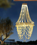Give Your Outdoor Patio A Major Glow Up With This Stunning Handcrafted Solar Crystal Chandelier Featuring Cascading Diamond Sparkles And Weather Proof White Metal Frame, 40 inch height.
