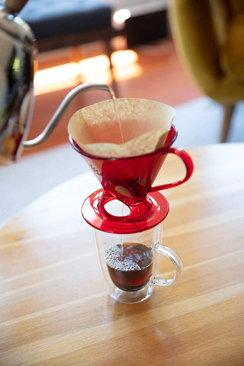 Unbleached Cone Coffee Filters For 1 Cup Drip Makers, Natural Brown, 40 Count. Brewing coffee in red dripper into glass mug.