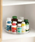 2 Pack 9 Inch Clear Lazy Susan Turntables For Cabinet Fridge Kitchen Pantry Storage Super Handy Organizers For Spices Seasonings Condiments And Everyday Kitchen Organization on a shelf with jars.