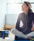 DIY FM Radio Kit 76 108 MHz With LCD Display and headphone jack used by woman in relaxed home setting
