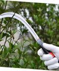 Gardener holding Two Piece Manganese Weeding Sickle With Comfy Grip For Gardening And Agriculture Use Sharp Blades in lush garden