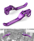Foldable Front And Rear Brake Levers For Surron Light Bee X S L1E And Segway X160 X260 6061 Aluminum CNC Adjustable Clutch Levers With Durable Fold Design In Purple Finish shown on a white background and installed on handlebars.