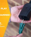 Weatherproof Outdoor Outlet Switch With Wireless Remote Controller held near brick wall