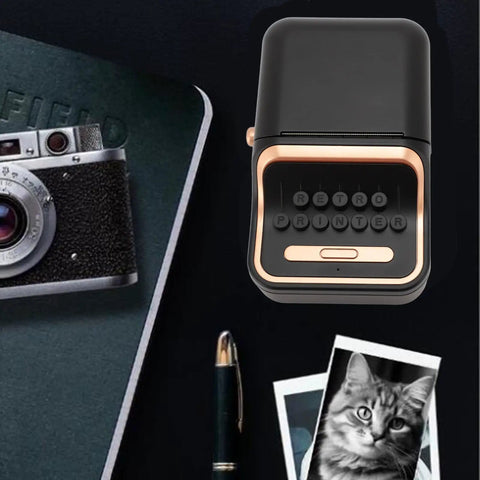 Cool Retro Label Printer With Bluetooth 5.0 Connectivity And Compact Design Perfect For Home Office Organization Tasks Features Inkless Thermal Printing Technology Compatible With A Range Of Paper Widths From Thirty Two Millimeters To Fifty Two on a desk with a vintage camera.
