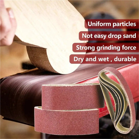 Five Piece Pack Of Top Shelf 915X100Mm Sanding Belts For Belt Sanders With Tough As Nails Abrasive Paper For Woodworking And Metal Jobs Delivering A Sweet Finish And Killer Grinding Power, showing sanding belts with wood.