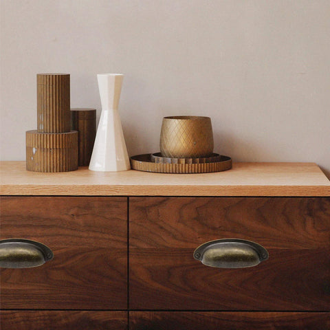 Wooden dresser with 8 Pack 3.5 Inch Center Vintage Farmhouse Cup Pull Handles in Flat Bronze, decor items on top