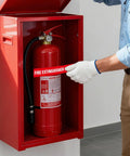 Must Have 10 Pack Fire Extinguisher Inside Signs being applied to a fire extinguisher cabinet. Waterproof vinyl sticker in use.