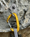 Heavy Duty Stainless Steel Climbing Bolt Hangers, UIAA Certified Rock Anchor Gear, M12 Mounting Plates For Rappelling, close-up of anchor clip on rocky surface.