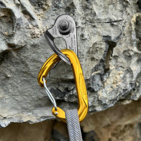 Heavy Duty Stainless Steel Climbing Bolt Hangers, UIAA Certified Rock Anchor Gear, M12 Mounting Plates For Rappelling, close-up of anchor clip on rocky surface.