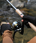 Angler holding two piece carbon fiber spinning rod and reel combo with 12 plus 1 shielded bearings in a freshwater setting