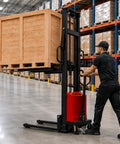 Heavy Duty 6000 Lbs Semi Electric Pallet Stacker With 118 Inch Lift Height and Smooth 5.2Kw Motor handling a wooden pallet in a warehouse.