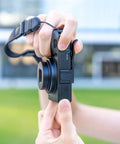 Side view of Metal Thumb Up Grip for Ricoh GR IV GR IV HDF and GR4 Monochrome Digital Cameras in use on a camera.