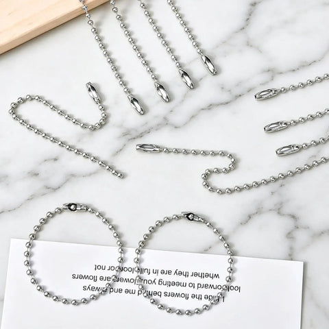 Bulk 500 Pieces Ball Chain Keychains, 3.9 Inch Beaded Dog Tag Chains, Silver Nickel Plated Key Chain Links, Connector Chains For Keychains, 2.4mm Bead Size laid out on marble