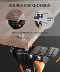 Close-up of heavy duty two inch caster wheels with dual locking brake design mounted on wooden surface.