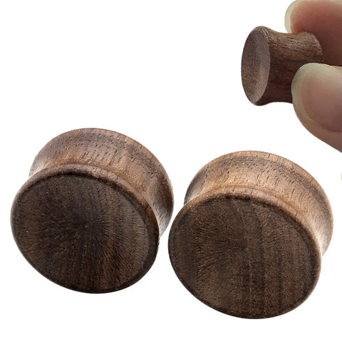 Close-up of Organic Wood Ear Gauges Set, 6 Pieces, Double Flared Saddle Plugs Stretcher, Three Quarter Inch 20mm, Brown Teak Finish.