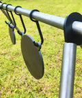 AR500 Steel Gong Target 3 Eighths Inch Thick For Precision Shooting hanging from metal stand on grass