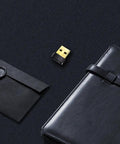 USB WiFi Adapter for PC N150 Nano Size Dongle on black background with notebook and envelope
