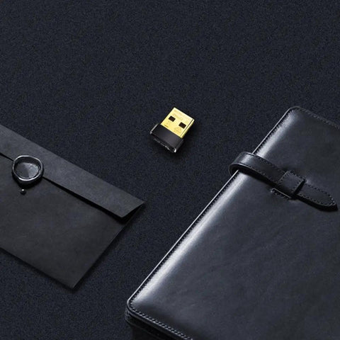 USB WiFi Adapter for PC N150 Nano Size Dongle on black background with notebook and envelope