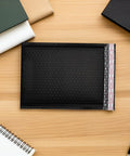 50 Pack Black Bubble Mailers For Shipping Clothes And Small Packages, Waterproof And Shockproof Padded Mailing Bags displayed on desk