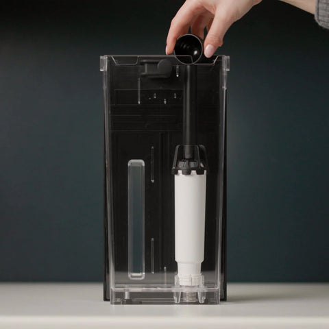 Front view of Amazon water filter cartridge for KitchenAid espresso machines, white cylindrical filter in clear housing.