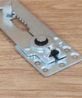Secure Your Sectional Couch With These Badass Heavy Duty Metal Sofa Connectors And Furniture Joint Clamps To Lock Every Piece In Place And Stay Straight Up Tough Daily, close-up view of a metal connector.