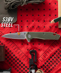 Fastball Slim Folding Knife With Lock Release on red background, 3 Inch S30V Wharncliffe Blade visible, EDC gear display.
