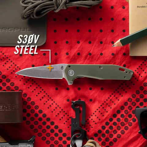 Fastball Slim Folding Knife With Lock Release on red background, 3 Inch S30V Wharncliffe Blade visible, EDC gear display.
