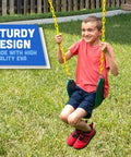 Child using Heavy Duty Strap Swing Seat With Carabiners For Easy Install, Replacement Swing Seat For Outdoor Playsets And Jungle Gyms, Green.