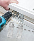 Drilling into wood with Six Pack Stainless Steel L Shaped Shelf Brackets with Slotted Holes, adjustable for DIY projects.