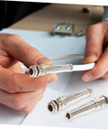 Hands holding Brass Cable Glands Kit 4 Pack With 2 Way Glands And Metal Connectors for secure wiring in electrical applications